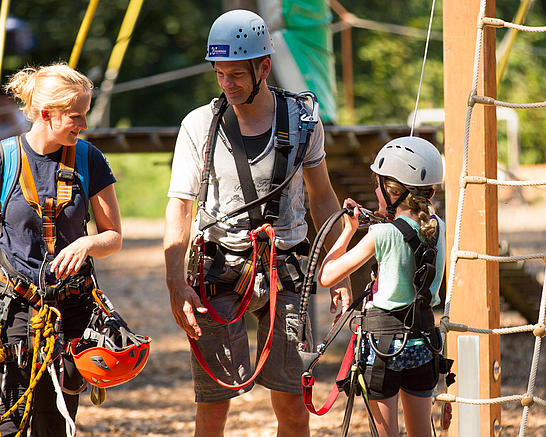 Vater und Kind nach der Gurtkontrolle durch eine Teamerin