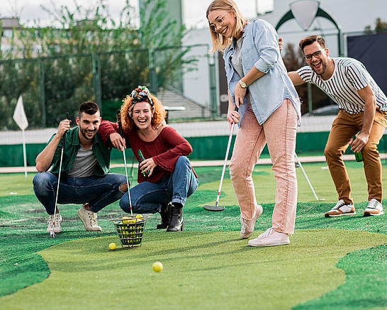 Eine Gruppe spielt Minigolf